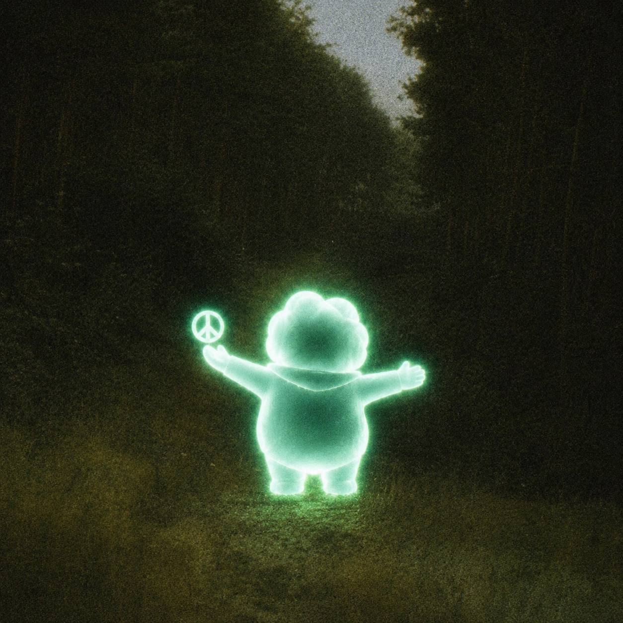 Ascend holding a peace symbol in a forest